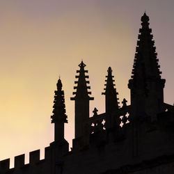 Low angle view of silhouette building against sky during sunset