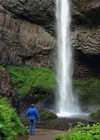 Man standing on waterfall