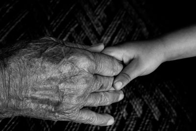 Cropped image of people holding hands