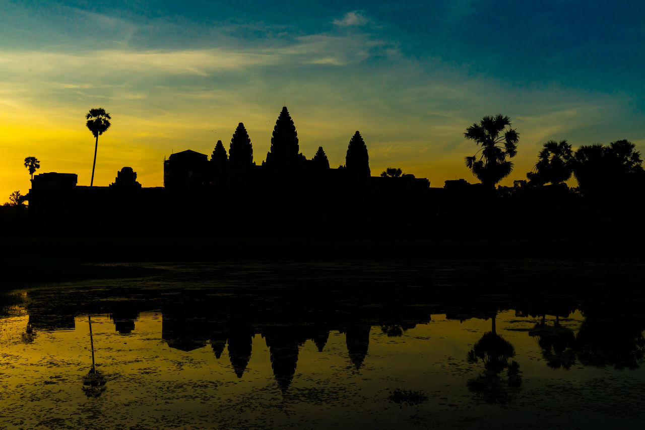 SILHOUETTE TEMPLE AGAINST LAKE DURING SUNSET