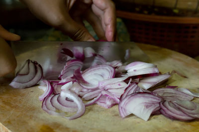 Close-up of person preparing food on cutting board