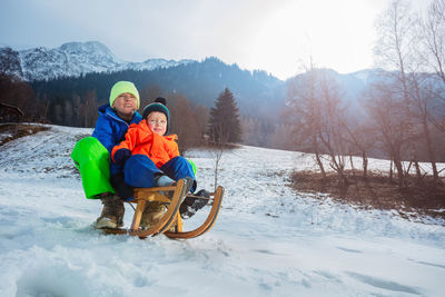 Portrait of man skiing on snow covered landscape