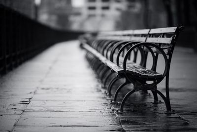 Empty benches on footpath