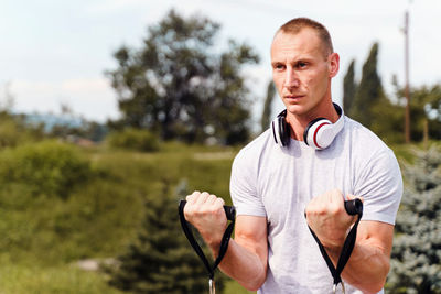 Portrait of mature man holding plant