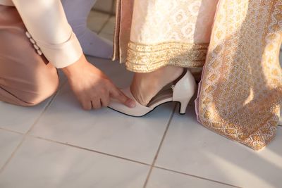 Low section of woman standing on floor