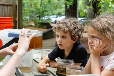 Two kids learning about animals that live in a state park