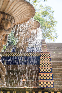 View of fountain by trees against sky