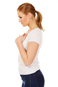 Side view of young woman against white background