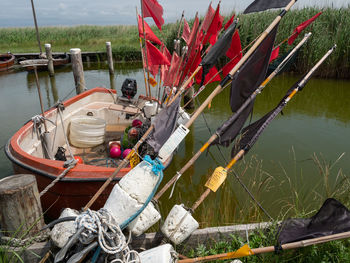 Fishing net on wooden post by lake