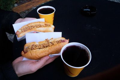 Midsection of person holding coffee cup