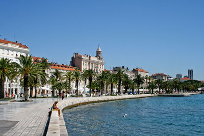 Buildings against clear blue sky