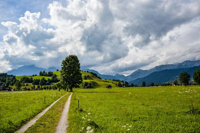 Scenic view of country road against sky