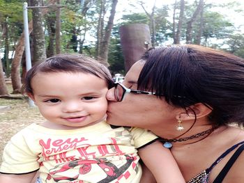 Portrait of mother and daughter in park