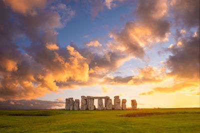 Amazing sunset at stonehenge in england with dramatic sky and sun rays