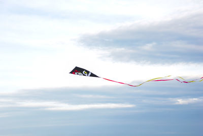 Low angle view of flags against sky