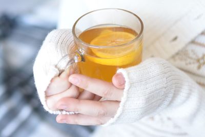 Midsection of woman holding tea cup