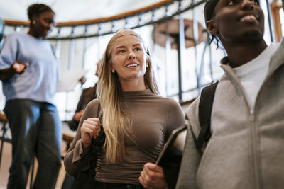 Portrait of smiling woman standing in city