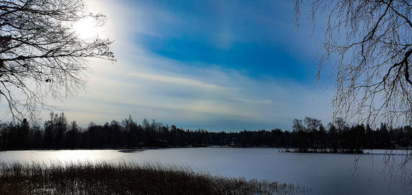 Scenic view of lake against sky during winter