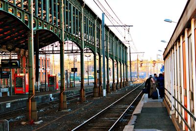 Man on railroad tracks against sky