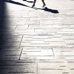 Low section of person walking on footpath