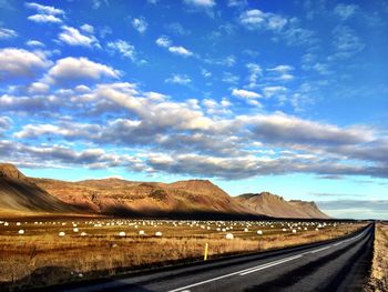 Empty road along countryside landscape