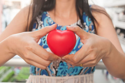 Midsection of woman holding balloons