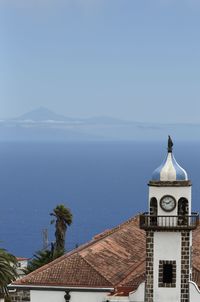 Building by sea against sky