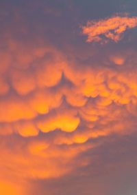 Low angle view of cloudy sky at sunset