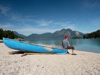 Fishing boat on shore. picturesque landscape of lake and green nature around in summer