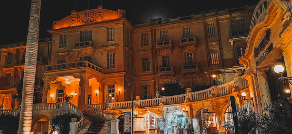 Low angle view of illuminated buildings at night