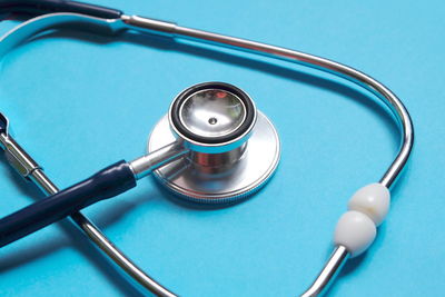 High angle view of stethoscope on blue background