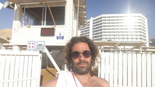 Portrait of mature man against built structure