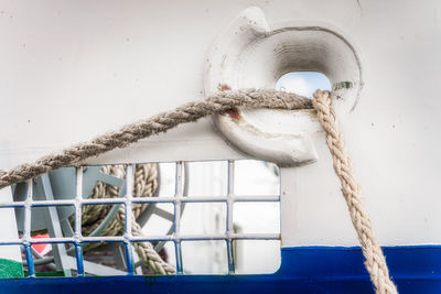 Close-up of rope tied on metal wall