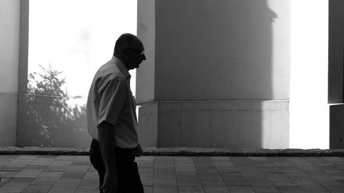 Rear view of man standing in city