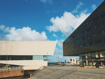 Low angle view of buildings against cloudy sky