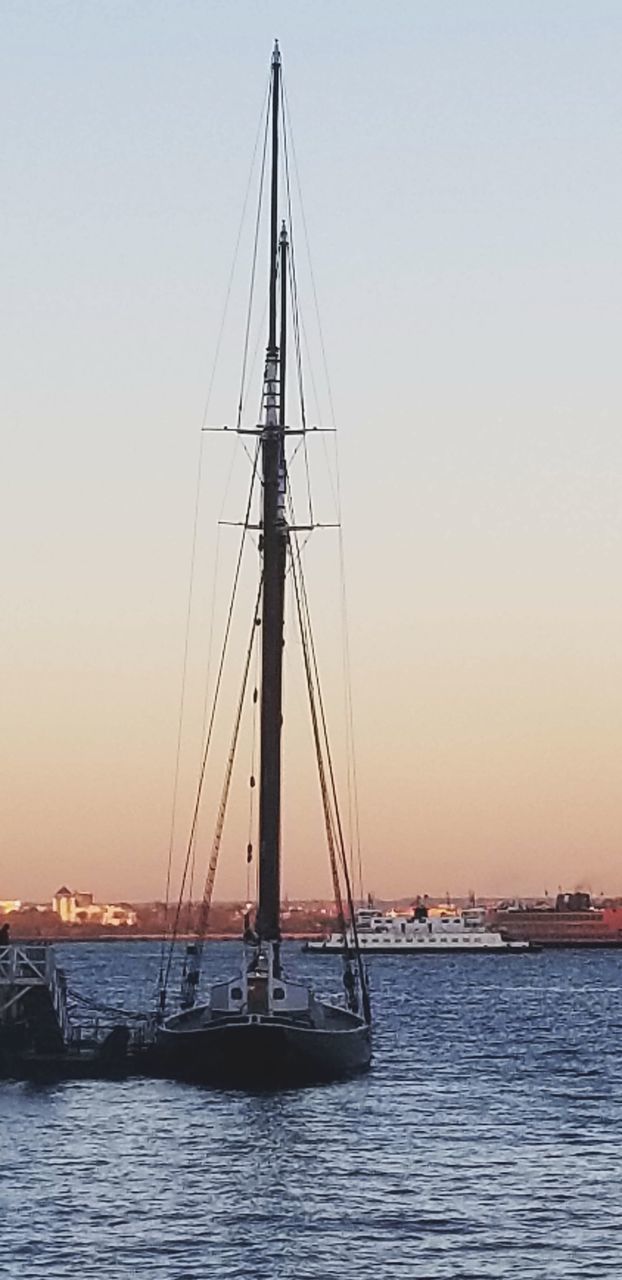 SAILBOAT SAILING IN SEA AGAINST CLEAR SKY