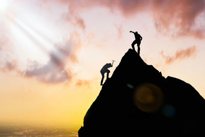 Low angle view of silhouette man against sky during sunset