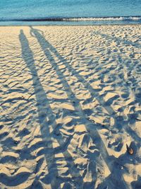 High angle view of footprints on sand at beach