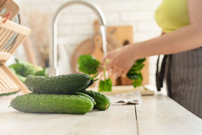  healthy eating and dieting. close up of table with green vegetables in the kitchen