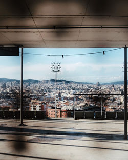 Cityscape against sky seen through glass window