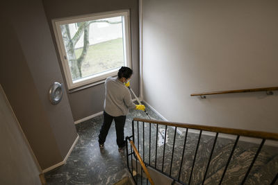 Woman mopping staircase