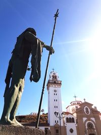 Low angle view of traditional windmill against clear blue sky