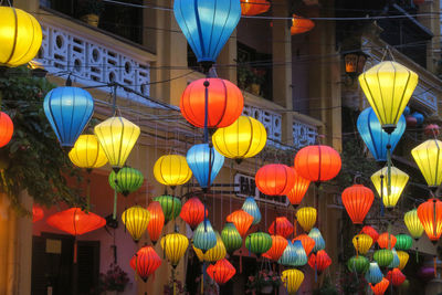 Low angle view of illuminated lanterns hanging at night