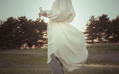 Side view of woman standing on field