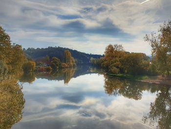 Reflection of trees in lake against sky