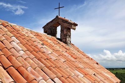 Low angle view of building roof against sky