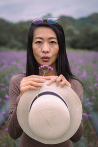 Portrait of young woman blowing bubbles