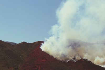 Smoke emitting from volcanic landscape