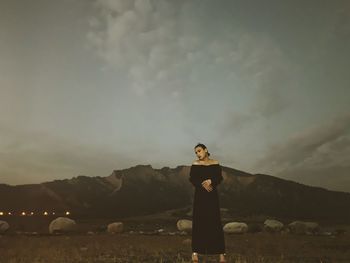 Man standing on land against sky