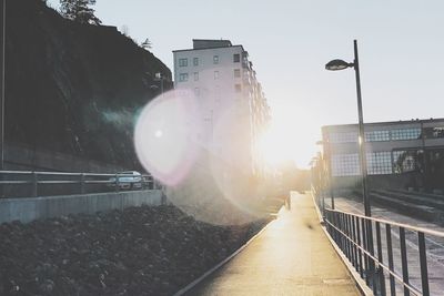 Road amidst buildings against sky